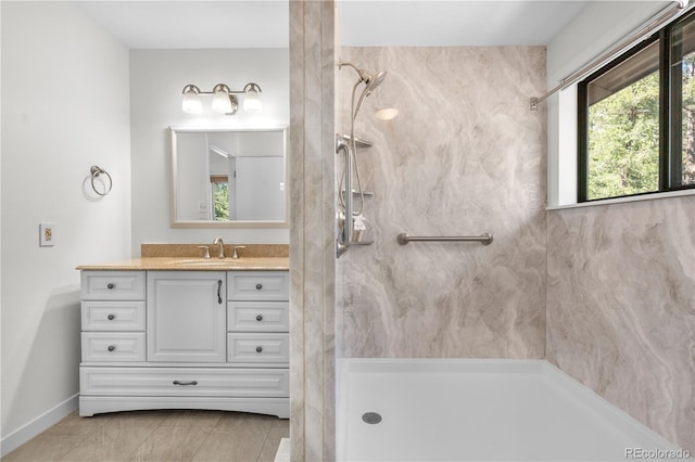 25531 Mosier Cir, Conifer, CO 80433 - bathroom featuring a marble finish shower, vanity, tile patterned flooring, and baseboards
