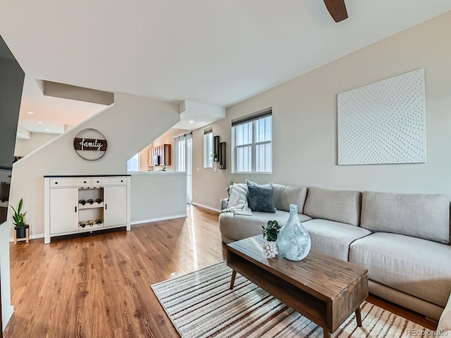 living room featuring light wood-style flooring and baseboards