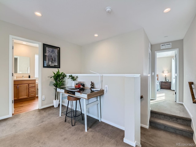 corridor featuring recessed lighting, visible vents, and carpet floors