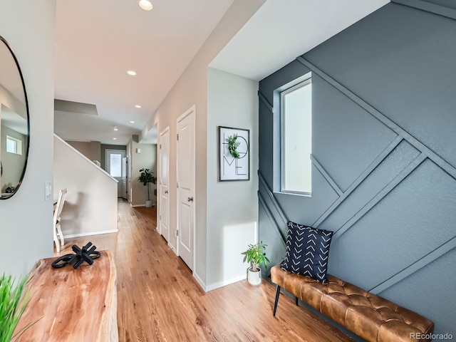 corridor featuring recessed lighting, wood finished floors, and baseboards