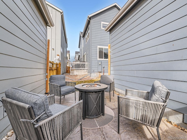 view of patio / terrace with fence and an outdoor fire pit