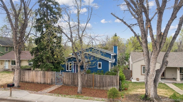 1617 W Boulder St, Colorado Springs, CO 80904 - view of front of property with a fenced front yard, central AC unit, and a chimney