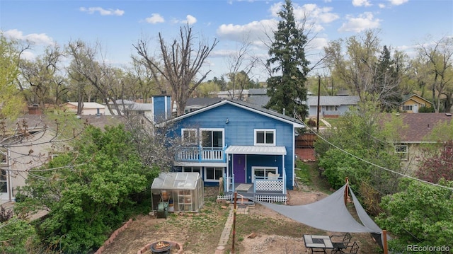 1617 W Boulder St, Colorado Springs, CO 80904 - view of front of property with a greenhouse, an outbuilding, a balcony, and a chimney