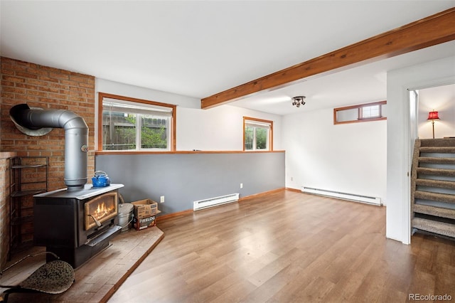 1617 W Boulder St, Colorado Springs, CO 80904 - unfurnished living room featuring a baseboard radiator, a wood stove, wood finished floors, and beamed ceiling