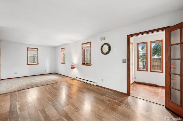 1617 W Boulder St, Colorado Springs, CO 80904 - empty room with baseboard heating, plenty of natural light, hardwood / wood-style floors, and baseboards