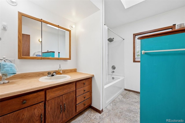 1617 W Boulder St, Colorado Springs, CO 80904 - full bathroom featuring a skylight, vanity, washtub / shower combination, and baseboards