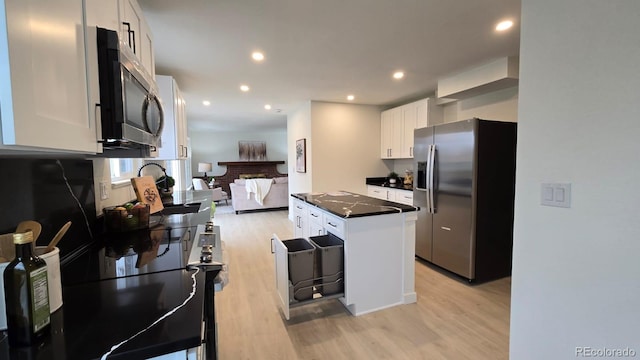 kitchen featuring dark countertops, white cabinets, light wood-style floors, stainless steel appliances, and recessed lighting