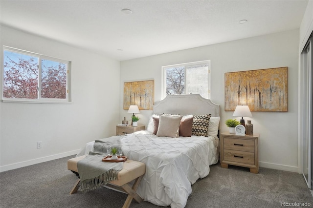 carpeted bedroom featuring baseboards