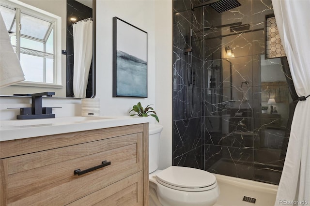 full bathroom with vanity, a marble finish shower, and toilet