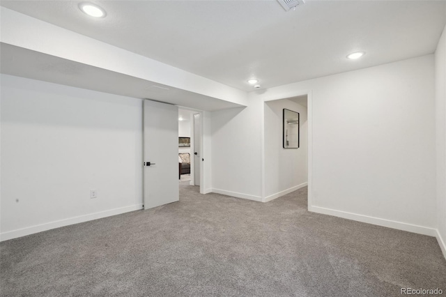 finished basement with baseboards, carpet flooring, recessed lighting, and visible vents