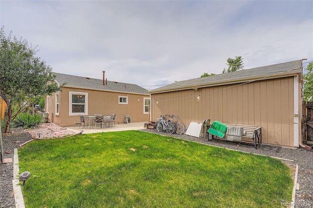 6736 Grove St, Denver, CO 80221 - back of house featuring a lawn and a patio area
