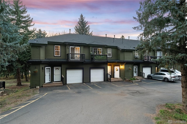 view of front of property featuring a balcony and an attached garage