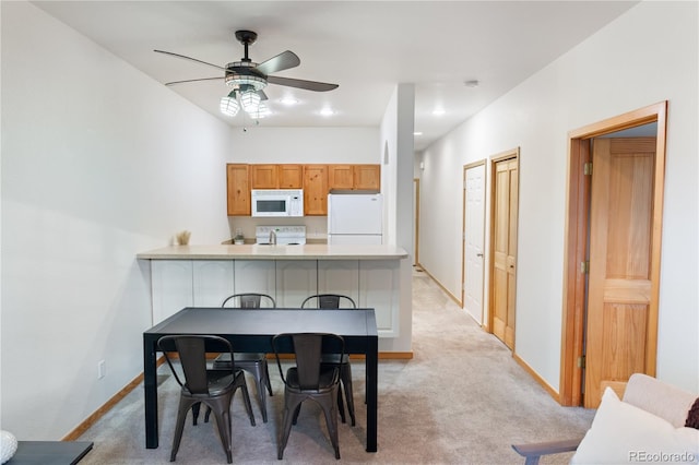 dining room featuring light carpet, recessed lighting, a ceiling fan, and baseboards