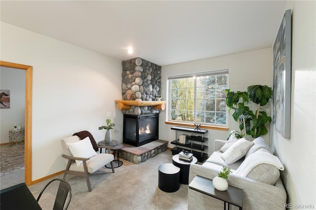 carpeted living room with baseboards and a glass covered fireplace