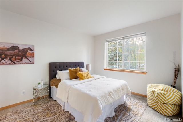 carpeted bedroom featuring baseboards