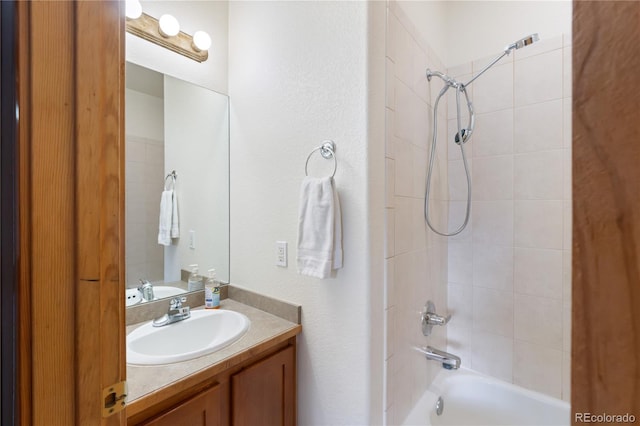 bathroom featuring bathing tub / shower combination and vanity