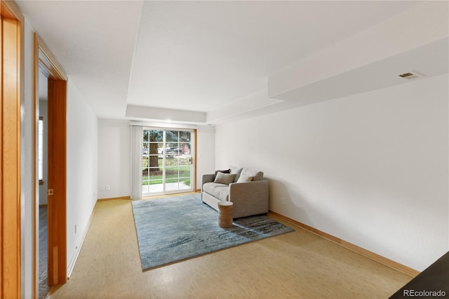 unfurnished room featuring baseboards, visible vents, and wood finished floors