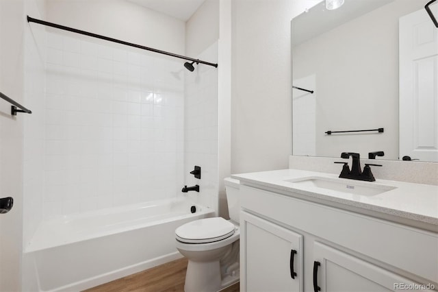 bathroom with shower / bathtub combination, toilet, wood finished floors, and vanity