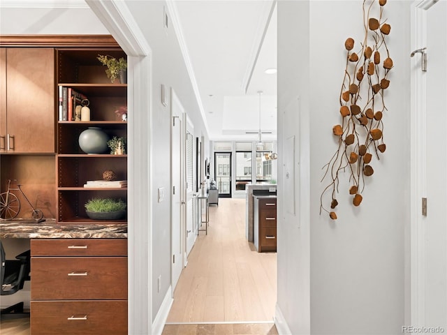 corridor featuring light hardwood / wood-style flooring and ornamental molding