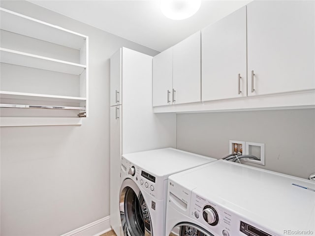 laundry area featuring cabinets and washer and clothes dryer