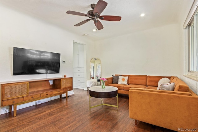 living room featuring hardwood / wood-style floors and ceiling fan