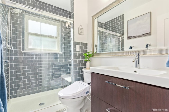 bathroom featuring an enclosed shower, vanity, and toilet