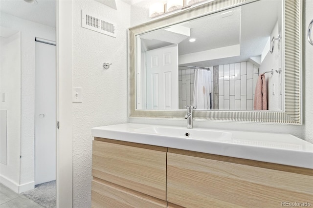 bathroom featuring vanity and tile patterned flooring