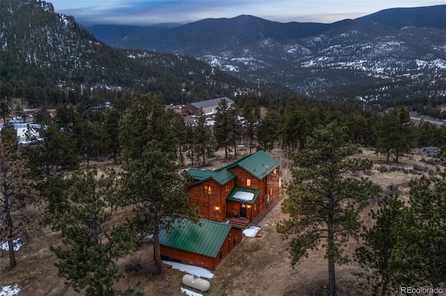 birds eye view of property with a forest view and a mountain view