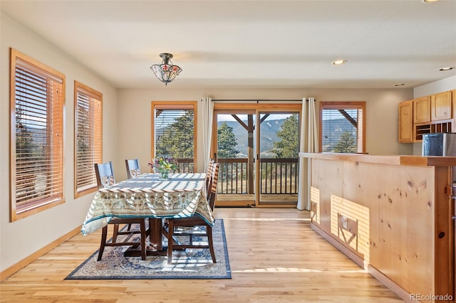 dining space with plenty of natural light, light wood-style floors, recessed lighting, and baseboards