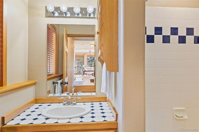 bathroom with vanity and a textured wall