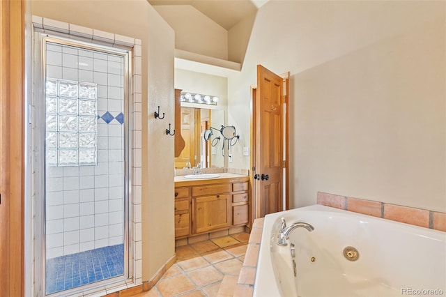 bathroom with a tub with jets, a stall shower, vanity, and tile patterned flooring