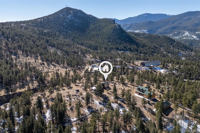 bird's eye view with a mountain view and a wooded view