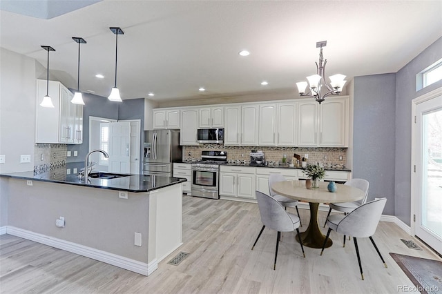 2901 Madison Ln, Broomfield, CO 80023 - kitchen featuring stainless steel appliances, a sink, light wood-style floors, backsplash, and recessed lighting