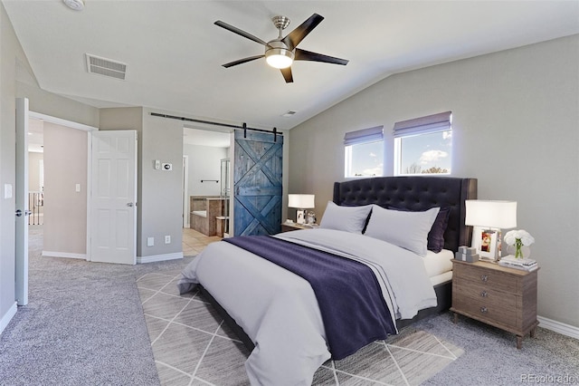 2901 Madison Ln, Broomfield, CO 80023 - bedroom with a barn door, light colored carpet, lofted ceiling, connected bathroom, and baseboards