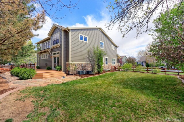 2901 Madison Ln, Broomfield, CO 80023 - view of property exterior with a deck, stone siding, and central air condition unit