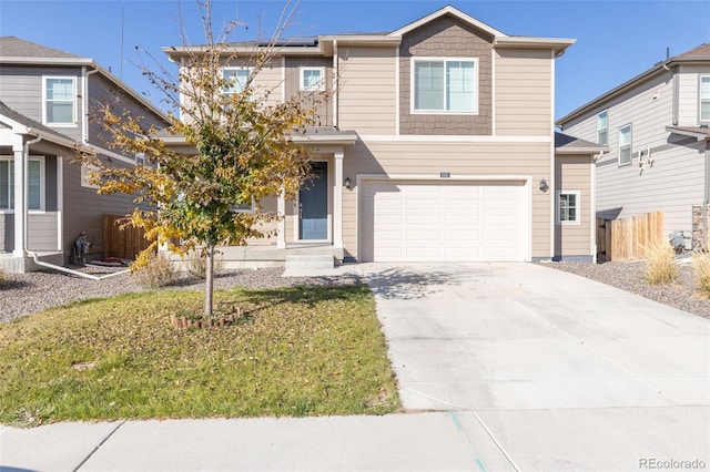 view of front of home with a front lawn and a garage