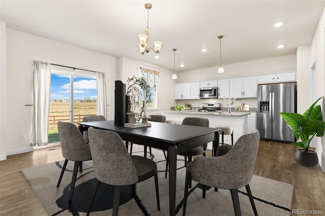 dining space featuring an inviting chandelier and dark hardwood / wood-style floors