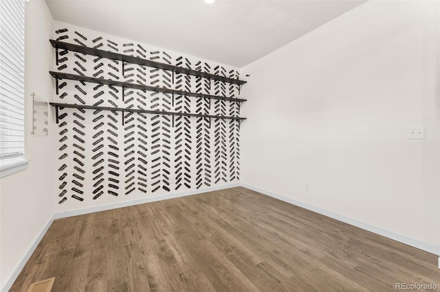 unfurnished room with hardwood / wood-style floors