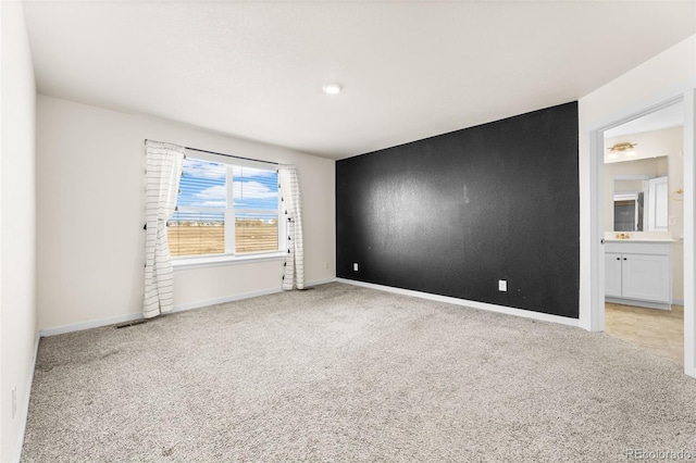 empty room with light colored carpet