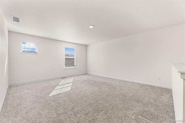 unfurnished room featuring light colored carpet