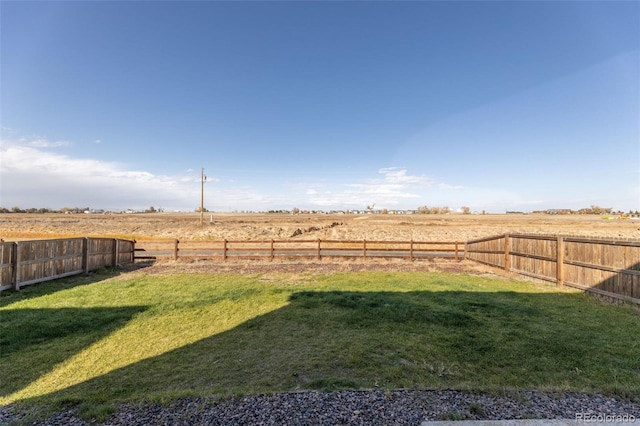 view of yard with a rural view