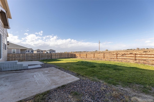 view of yard featuring a rural view and a patio