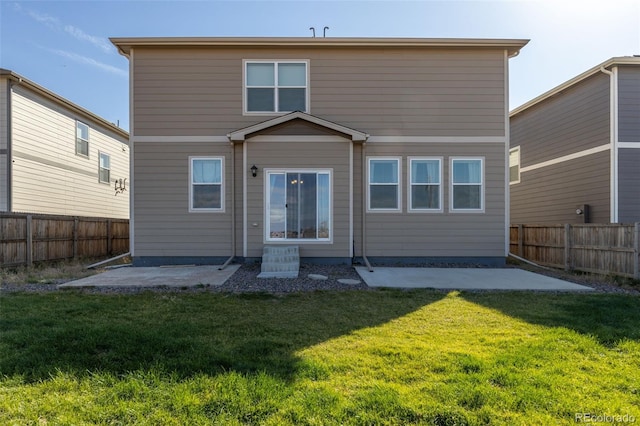 back of property featuring a patio area and a lawn