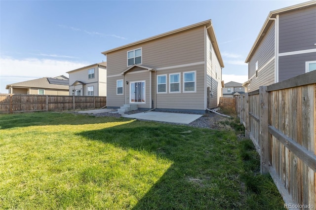 rear view of property with a patio area and a lawn