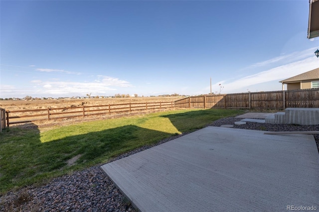 view of yard with a patio area and a rural view