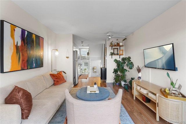 living room with ceiling fan and wood-type flooring