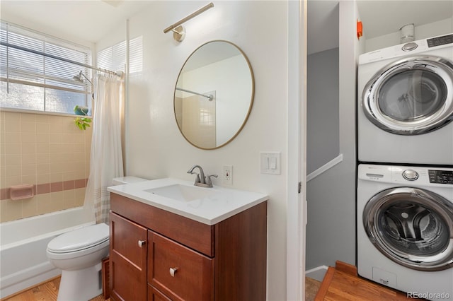 interior space featuring stacked washer and dryer, light hardwood / wood-style flooring, and sink