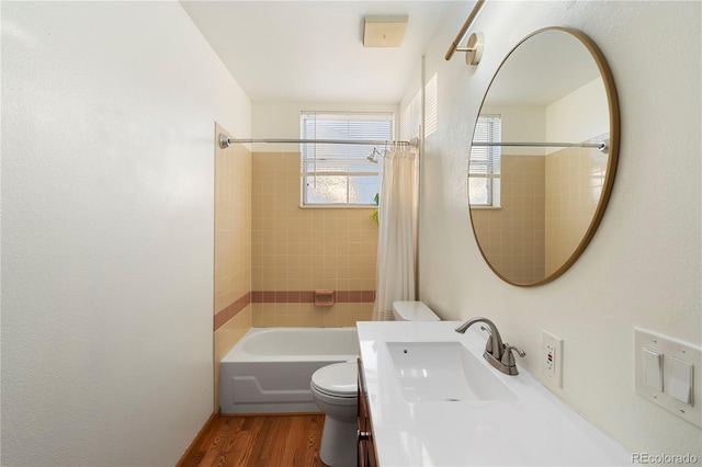 full bathroom with hardwood / wood-style floors, shower / bath combo with shower curtain, a healthy amount of sunlight, and toilet