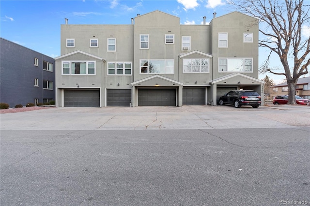 back of property with a garage