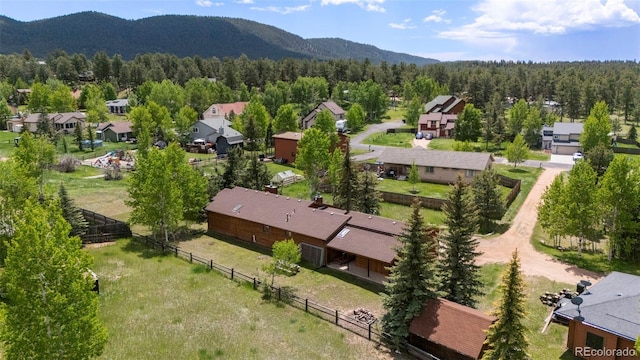1908 Valley View Dr, Woodland Park, CO 80863 - aerial view of residential area featuring a mountainous background and a heavily wooded area